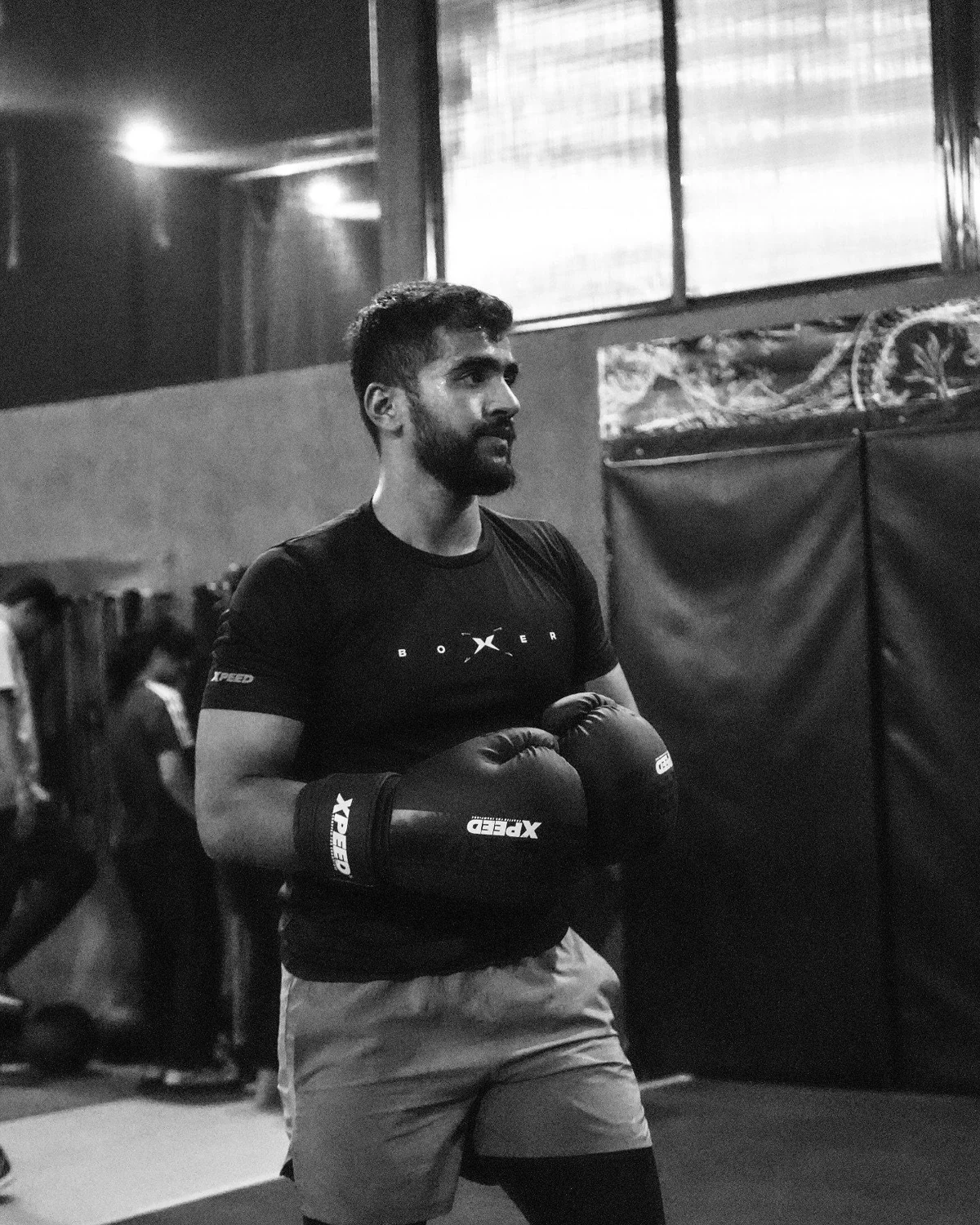 Abdeali wearing boxing gloves during training